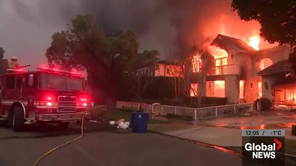 Fire truck in front of a burning house